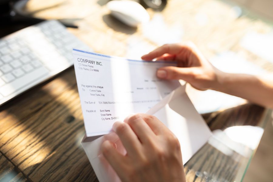 A person holding an envelope with a receipt on it.