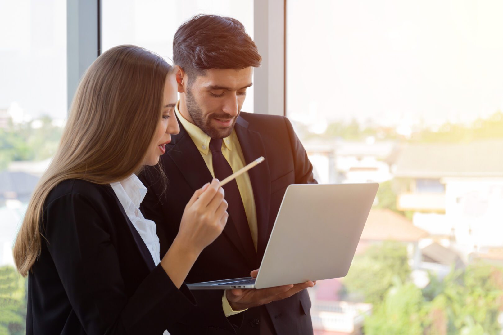 A man and woman looking at a laptop