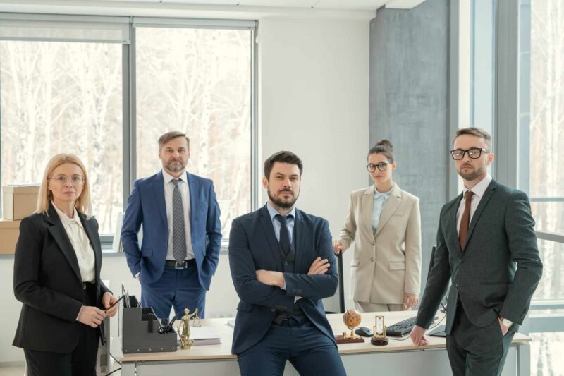 A group of people in suits and ties standing around.